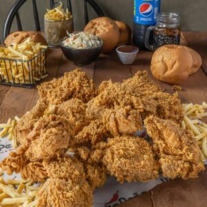Shop1 Delicious crispy fried chicken served with french fries, buns, coleslaw, and a refreshing drink.
