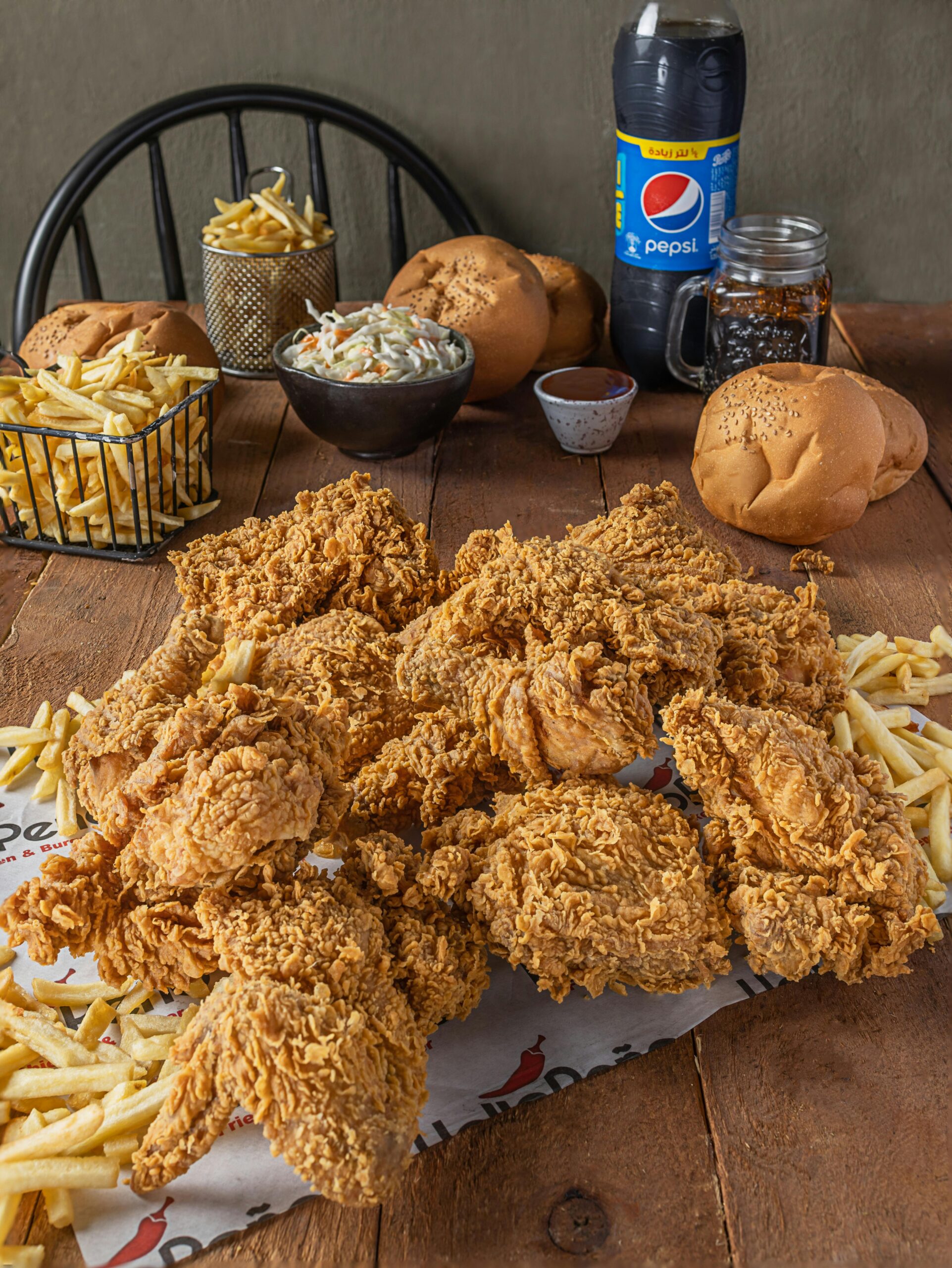 pexels photo 14686448 14686448 Delicious crispy fried chicken served with french fries, buns, coleslaw, and a refreshing drink.