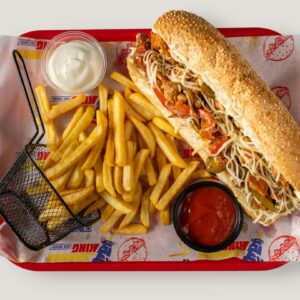 Shop1 Tasty sub sandwich with crispy fries, ketchup, and mayonnaise dip served on a tray.