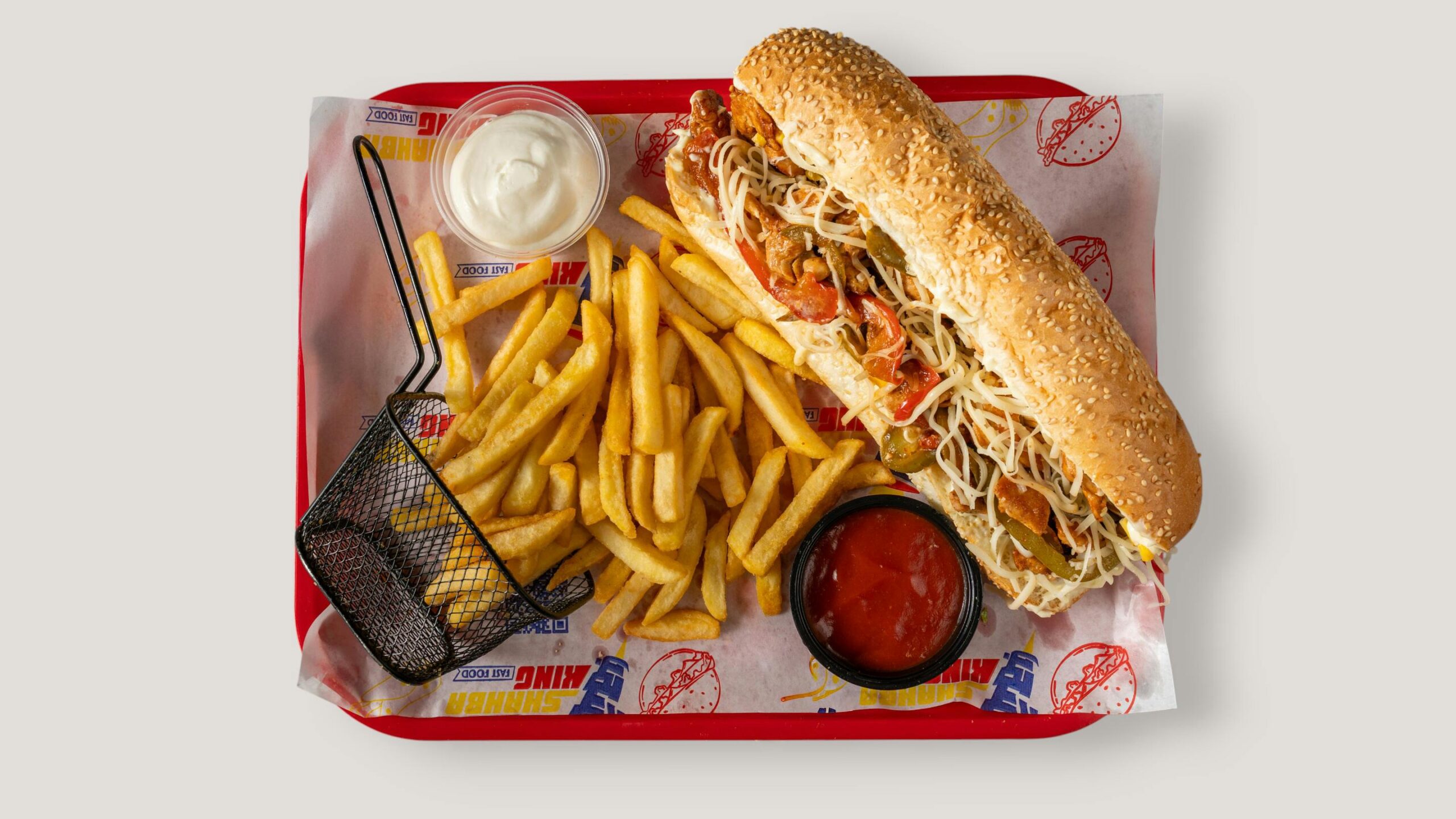 pexels photo 36879228 36879228 Tasty sub sandwich with crispy fries, ketchup, and mayonnaise dip served on a tray.