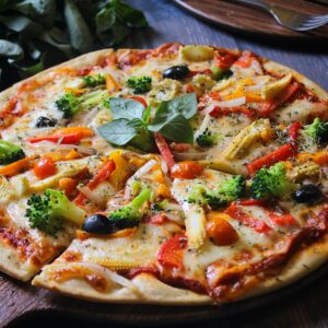 Shop1 Delicious homemade vegetable pizza with fresh toppings including broccoli, olives, and tomatoes.